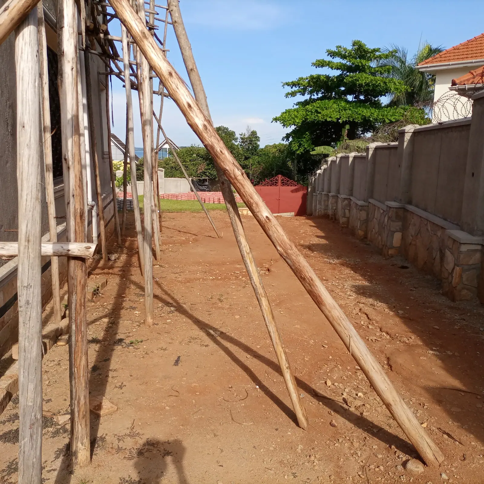 The unpaved route beside the house during work on site.