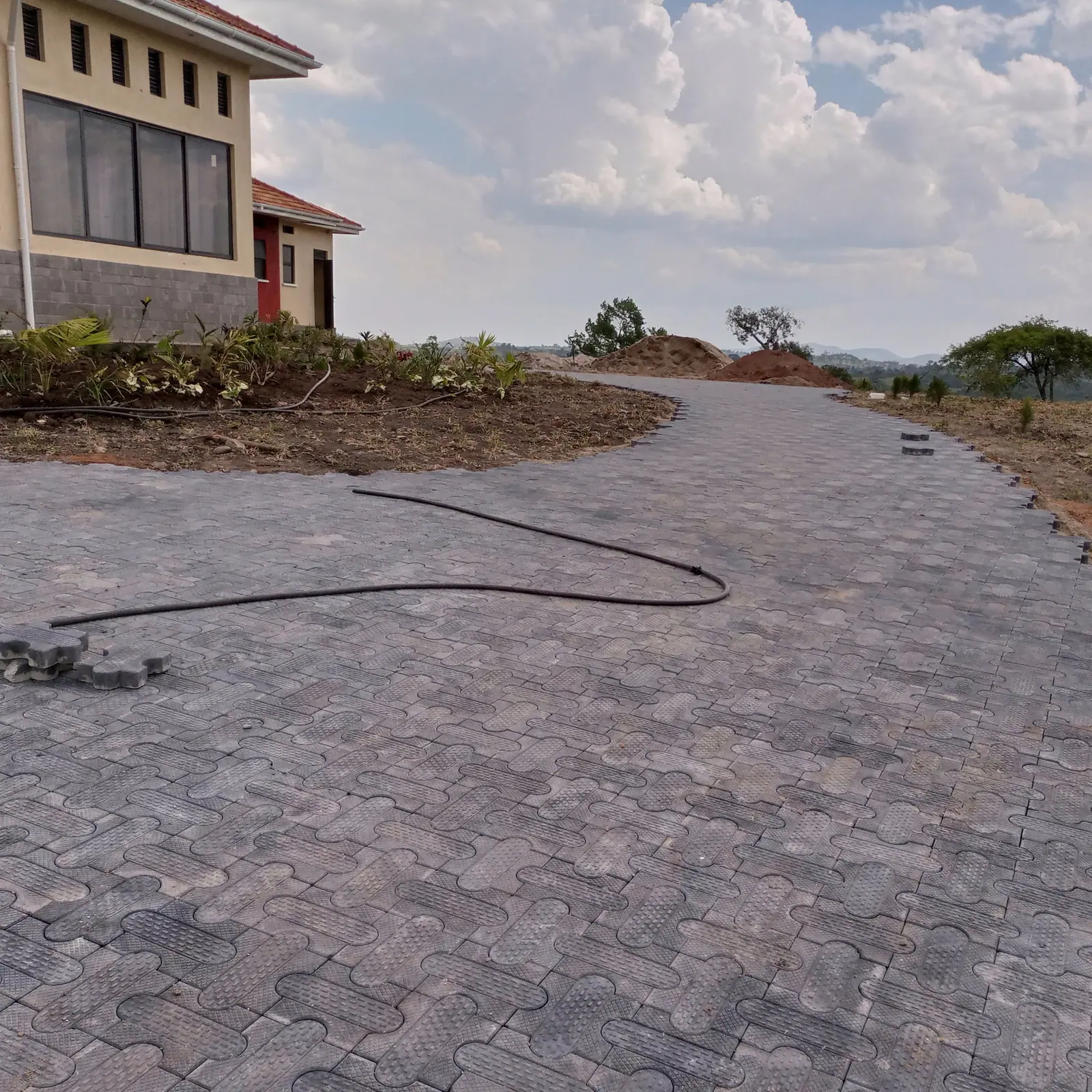 Interlocking pavers curve around the house.